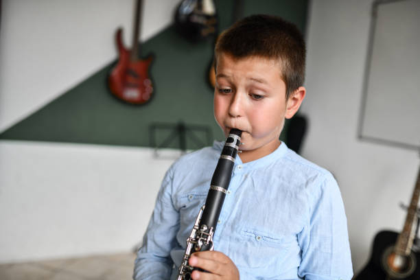 istock Focused Boy Blowing Air Into Clarinet In Classroom 1417422165