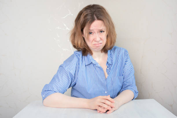 istock disgust, aversion, revulsion, distaste, repulsion, abomination, a woman with a grimace sits at the table 1417422372