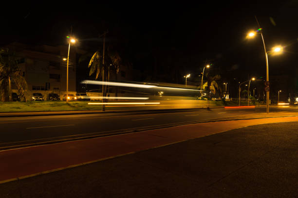istock Colorful light trails with motion blur effect of a bus, long time exposure. 1417423623