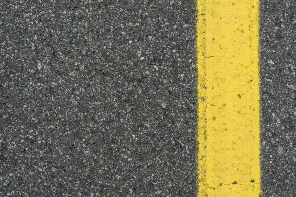 istock yellow markings on asphalt 1417423806