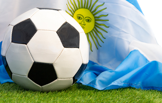 Soccer ball with the Argentine flag, on the grass of the field