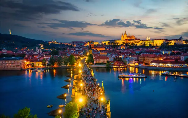 Evening lights on Charles Bridge in Prague, aerial view