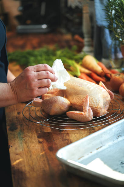 istock Preparing Roasted Chicken with Root Vegetables in Domestic Kitchen 1417429967
