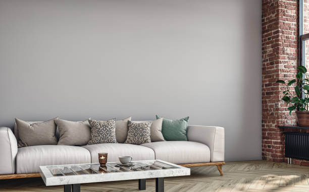 istock Empty nostalgic retro living room with beige sofa,  colored cushions, coffee table, and decoration (potted plant) in front of a colored wall and partly ruined brick wall 1417439563