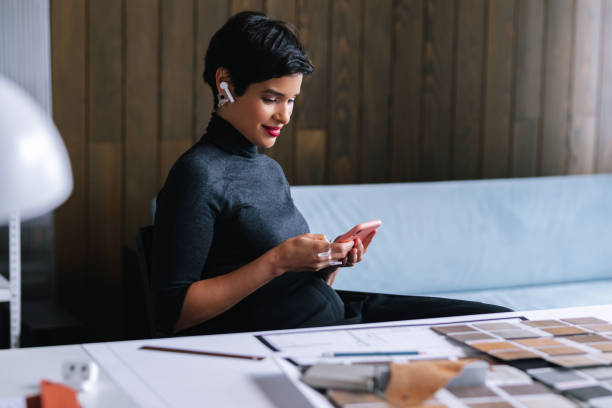 istock Woman Texting On Her Smartphone In Her Home Office 1417441875