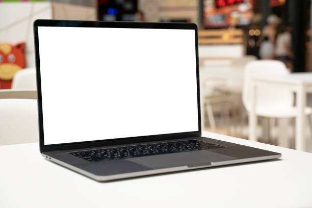 istock Laptop with white screen in business office or shopping mall. Empty copy space, blank screen mockup. Soft focus laptop with interor background. Travel, study and office work concept. 1417443404