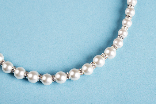 Necklaces of white and black pearls in the form of a sign of infinity on silk. Greeting card for the wedding, International Women's Day March 8, Valentine's and Mother's  Days.