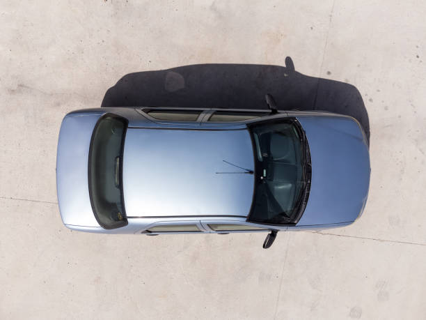Aerial top view of a blue colored Fiat brand albea model 2006 car on the road. stock photo