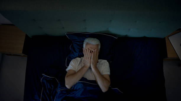 istock Anxious, mature man trying to sleep at night. Dealing with sleeping disorder, head in hands 1417450552