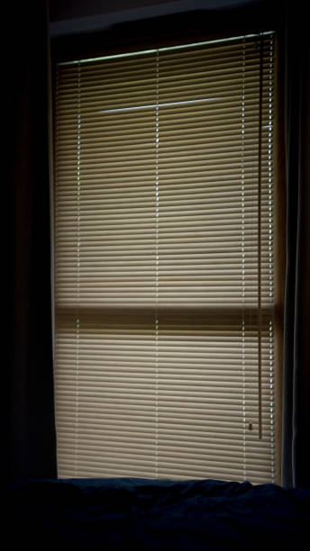 istock Close up on blinds hanging on the window. Dark bedroom 1417450656