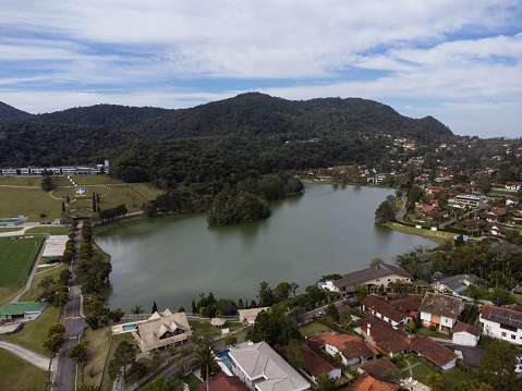 Aerial view of Granja Comary, Carlos Guinle neighborhood in the city of Teresópolis. Mountain region of Rio de Janeiro, Brazil. Drone photo. Houses, lake and hills and mountains.
