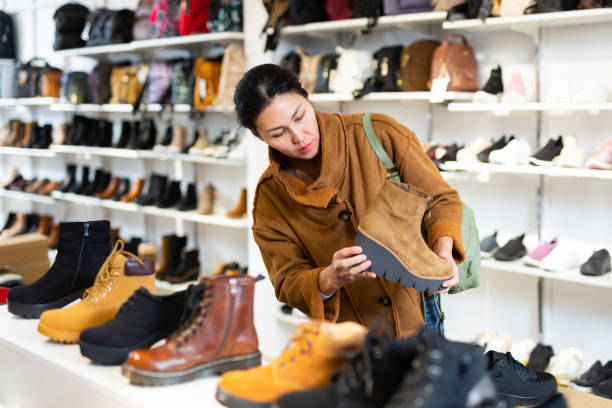 istock Asian woman chooses autumn halfboots 1417457702
