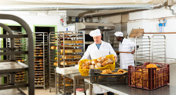 istock Portrait of baker with fresh bread at the bakery 1417458422