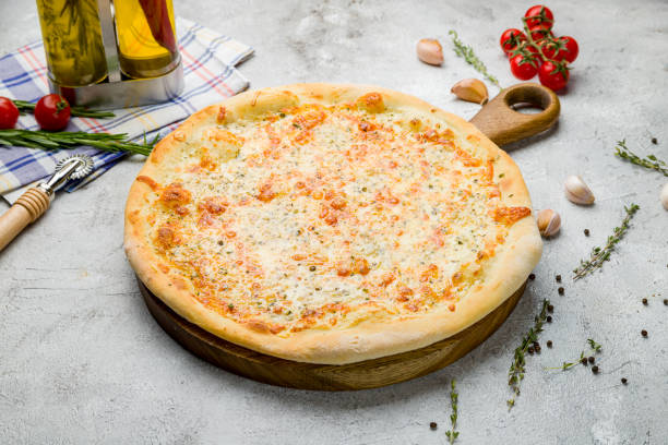 istock Pizza Quattro formaggi on the board on grey table 1417463512