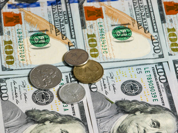 istock Coins lie on dollar banknotes. 1417471195