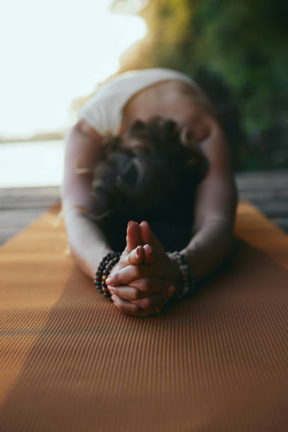 istock A woman practices yoga on the dock. 1417476706