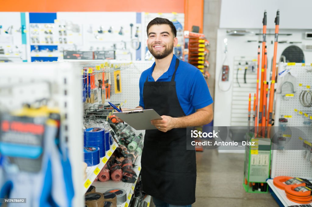 Work In Store Retail Worker Looking Cheerful While Doing Inventory At The Hardware ...