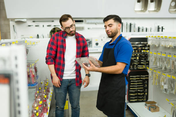 istock Happy employee helping a customer buying at the hardware store 1417478745
