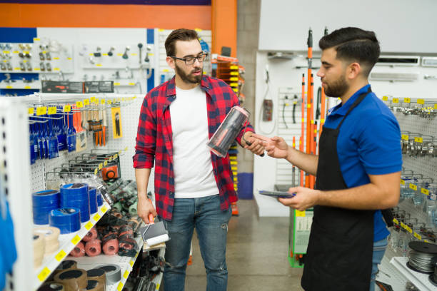 istock Young man asking for advice to the hardware store employee 1417478749