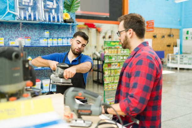 istock Smart hardware store worker helping a customer to buy power tools 1417478762