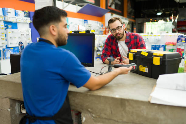 istock Young man paying for a tool box at the hardware store 1417478838