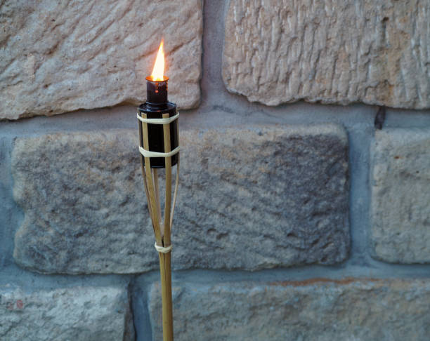 bamboo porch torch on the sandstone wall background