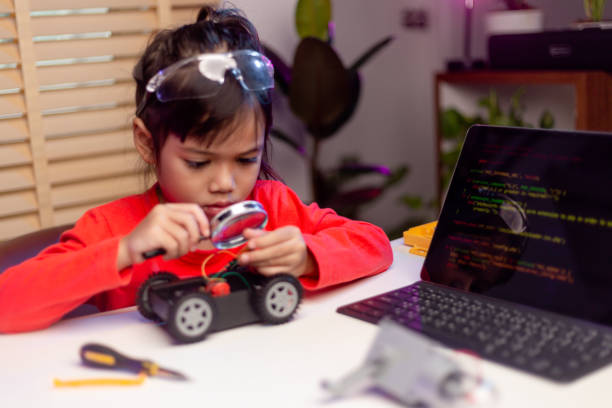 istock Asia students learn at home in coding robot cars and electronic board cables in STEM, STEAM, mathematics engineering science technology computer code in robotics for kids concept. 1417503924