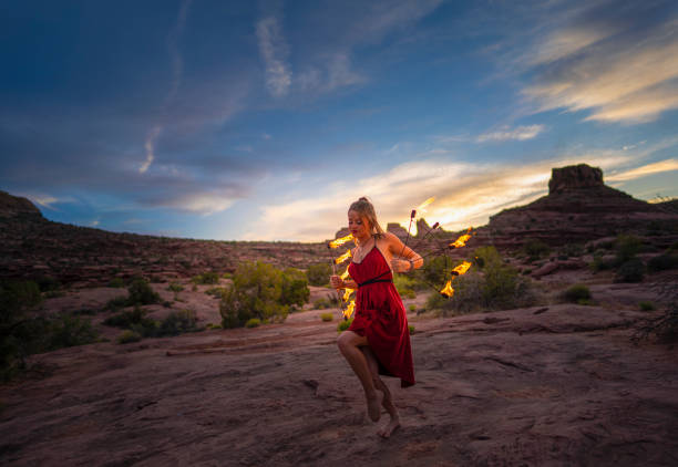 Young woman dancing with fire