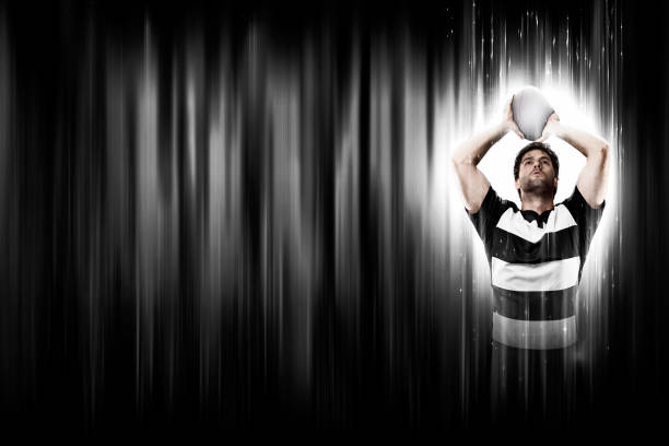 Rugby Player with a white uniform on a black and white background looking like a super hero.