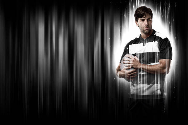 Rugby Player with a white uniform on a black and white background looking like a super hero.