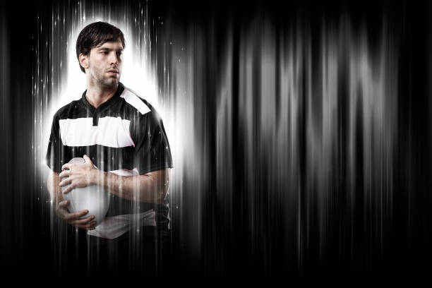 Rugby Player with a white uniform on a black and white background looking like a super hero.