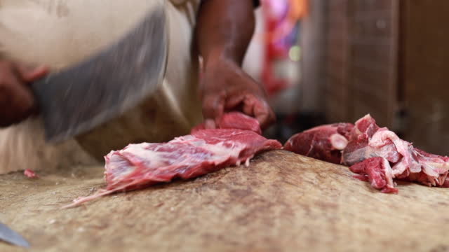 A butcher chopping meat close up