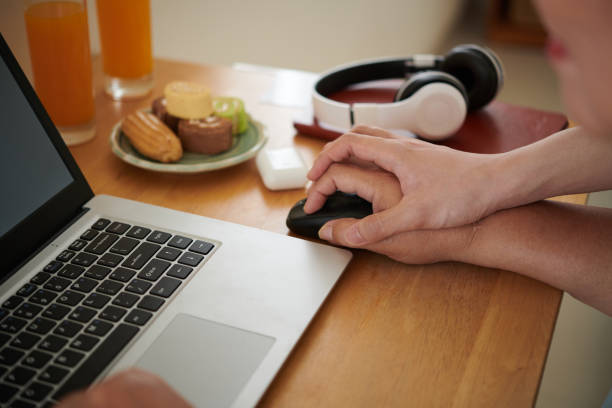 istock Man Showing Grandmother How to Hold Computer Mouse 1417518654