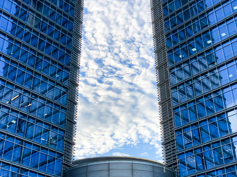 Sky and white clouds between two buildings