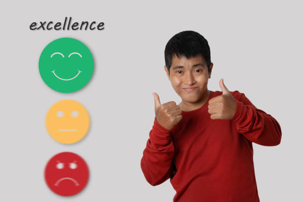 istock Young man showing approving doing positive gesture with happy Smiley face icon to give satisfaction in service. 1417519491