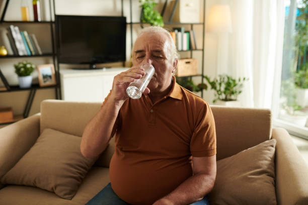 istock Aged Man Drinking Glass of Water 1417519654