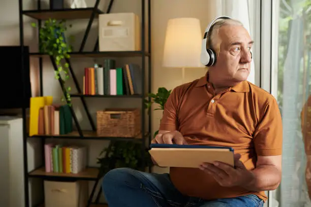 Photo of Pensive Man Watching Music Videos