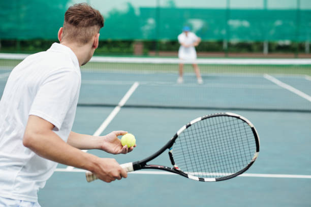istock Man Playing Tennis with Friend 1417521734