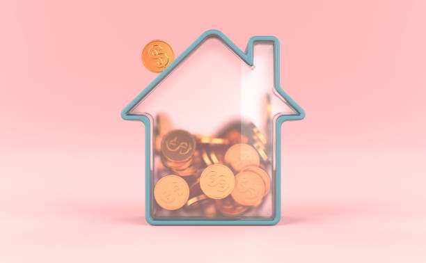 Glass House with Gold Coins Inside. House Savings Concept stock photo
