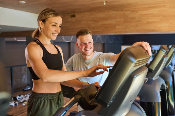 istock Woman training with instructor in gym 1417533738