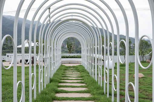 White arched corridor on green grass