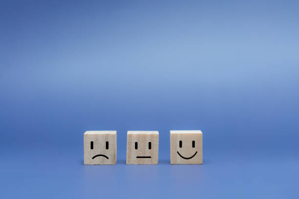 istock Emotion face on wooden cube.  Ranking for service customer review and feedback concept 1417538358