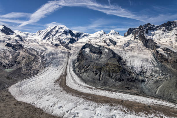 Grenzgletscher - Border Glacier - Gorner Glacier Monte Rosa in Summer under blue sunny skyscape. Gorner and Grenz glacier (German: Gornergletscher, Grenzgletscher). On the left side the Monte Rosa massif is situated with the peaks Nordend and the Dufourspitze . The Dufourspitze is the highest peak in Switzerland. In the middle is the Lyskamm and on the right side the twins Castor (4223 m) and Pollux (4092 m) are located.View from Gornergrat Mountain Top. Gornergrat, Zermatt, Valais Canton, Switzerland, Europe.