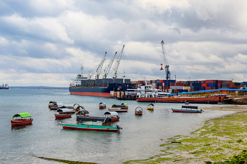 Port of Zanzibar with big ships, cranes and cargos near the quay in Stone Town, Zanzibar, Tanzania