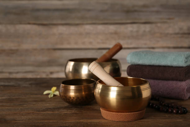 istock Composition with golden singing bowls on wooden table, space for text 1417543344