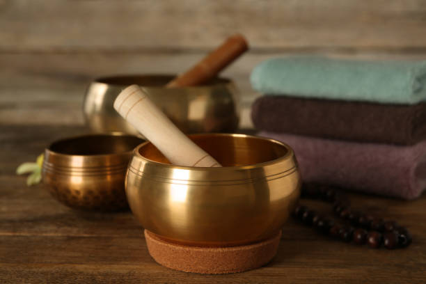 istock Composition with golden singing bowls on wooden table 1417545510