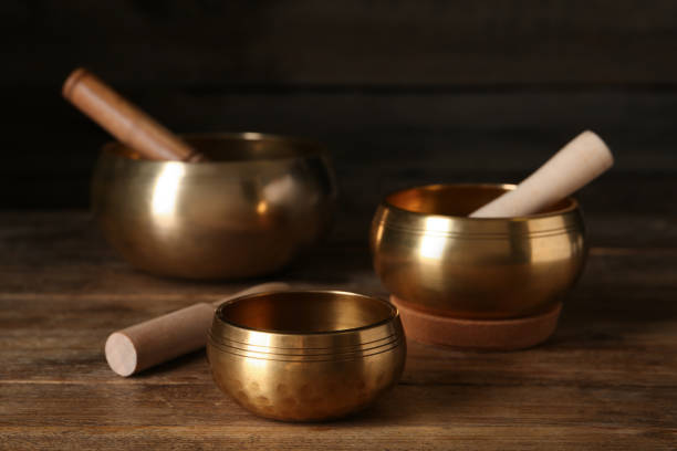 istock Golden singing bowls with mallets on wooden table 1417546089