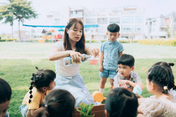 istock Pre- school teacher teaching children about plants  in nursery, 1417547926