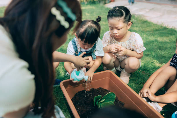 istock Pre- school teacher teaching children about plants  in nursery, 1417547936
