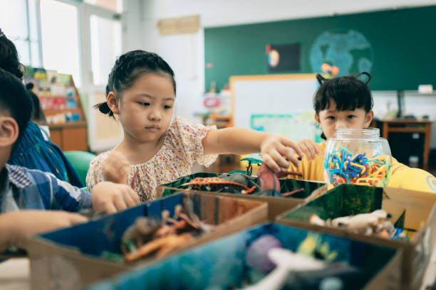 istock Preschool children playing with teaching aids in classroom 1417548052